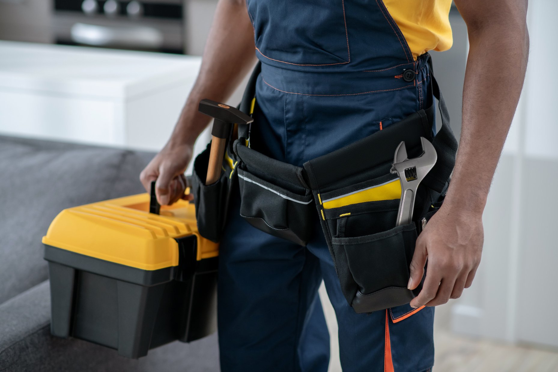 Handyman Carrying a Tool Box Indoors Closeup